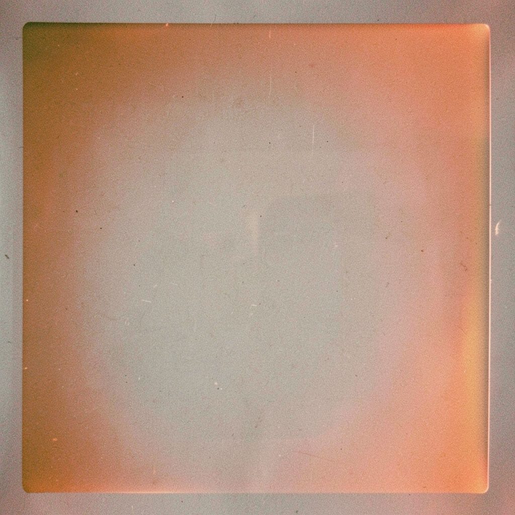 Muted analog photograph of bishops gathered in a sunlit assembly hall, warm gray and amber tones, visible film grain.